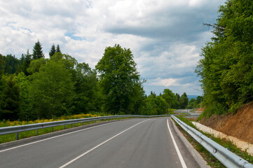 highways in the mountains against the background of the sunny sky and the white clouds
