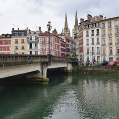 BAYONNE, FRANCE - 30 Oct, 2021: Old houses by the river La Nive in the center of Bayonne, Aquitaine, France