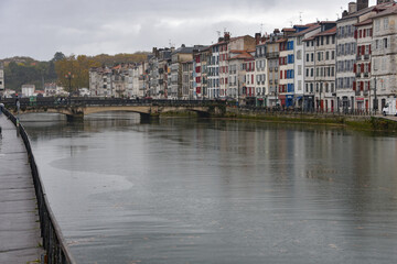 BAYONNE, FRANCE - 30 Oct, 2021: Old houses by the river La Nive in the center of Bayonne, Aquitaine, France