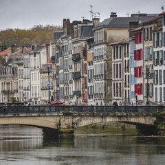 BAYONNE, FRANCE - 30 Oct, 2021: Old houses by the river La Nive in the center of Bayonne, Aquitaine, France
