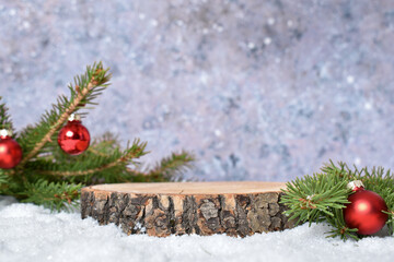Minimal. Christmas background with a podium in the snow for a product presentation with a fir...