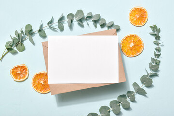 The layout of the invitation with eucalyptus and oranges. Eco concept.