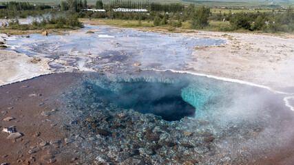 Impressive view of Icelands Geysir Geisir in the Golden Circule, the geothermal activity and a attraction for tourists in Iceland