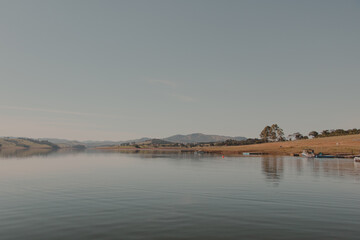 calm lake water with land on the horizon