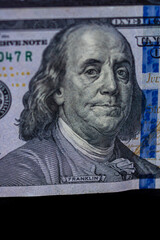 Selective focus on detail of 100 dollars banknote. Close up macro detail of money banknotes,...