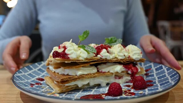 Millefeuille dessert at a restaurant in a blue plate