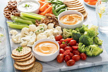 Plant based snack board with vegetables and crackers