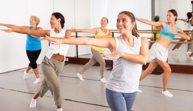 Group of women different ages training sport dance in modern studio
