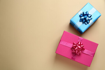 Colorful gift boxes on beige background, flat lay. Space for text