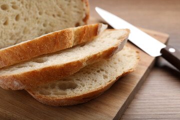 Cut tasty wheat sodawater bread on wooden table, closeup