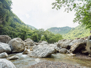 Boulders among river in mountains