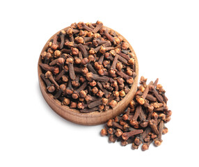 Aromatic dry cloves and wooden bowl on white background, above view