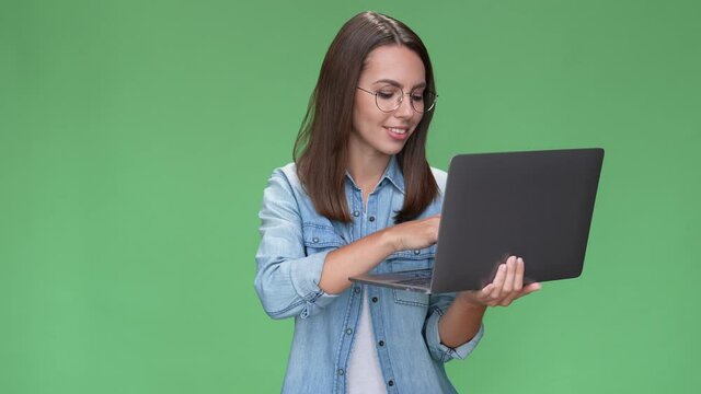 Lady geek use netbook type colleague review isolated green color background