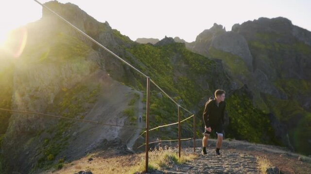 Man climbing beautiful PR1 Pico do Arieiro - Pico Ruivo trail; Madeira Portugal