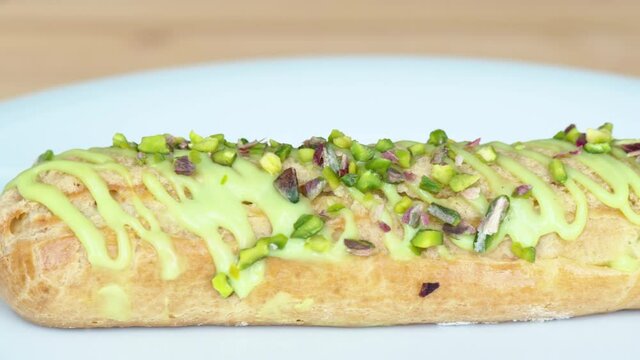 White eclair dessert with fistic nuts and cream