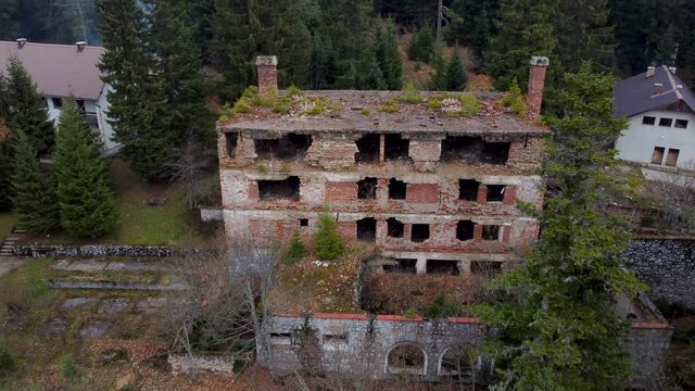 Aerial drone view of ruined and damaged buildings as war aftermath in Bosnia and Herzegovina. Buildings destroyed and burned in war by artillery. Abandoned buildings.  
