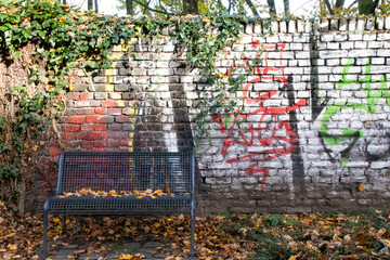 Brick Wall with Graffity and Bench