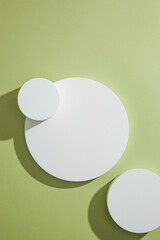Top view of circle , square white podium ,  in green background and blank space for advertising , abstract content  