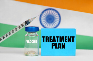 Vaccine, syringe and blue plate with the inscription - TREATMENT PLAN. In the background the flag...