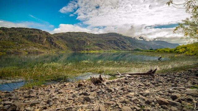 Time lapse video of a beautiful lake and mountain in Desemboque. Steady cam shot from shoreline of the lake.