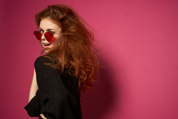 beautiful woman fashionable hairstyle sunglasses posing pink background