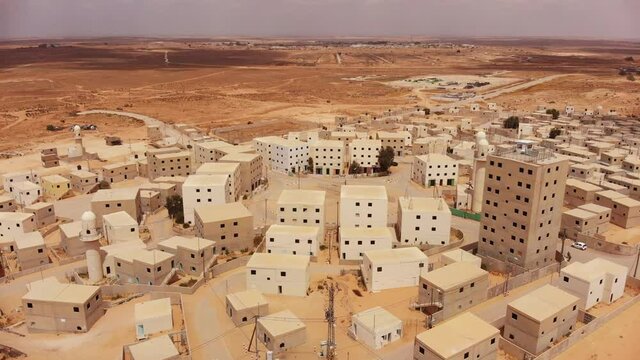 aerial shot of an old empty city in the desert in palestine near Gaza at morning around the buildings and the mosques next to the main squre of the city