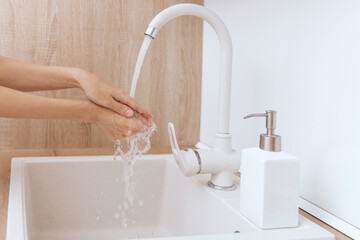 Washing hands under the flowing water tap. Washing hands rubbing with soap for corona virus prevention, hygiene to stop spreading corona virus in or public wash room. Hygiene concept hand detail