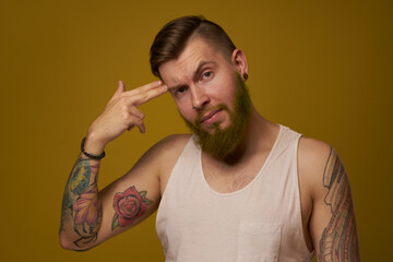 macho man in white t-shirt tattoos on his arms posing isolated background