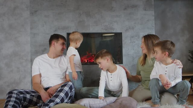 Happy loving parents, little children together hug, calm family together relax