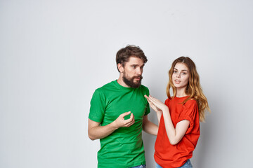 Fototapeta premium married couple multicolored t-shirts communication quarrel isolated background