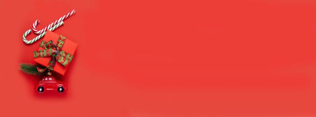 Car, gift, lollipop, candy on a red background.