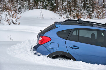 Car stuck in deep snow on cold winter day