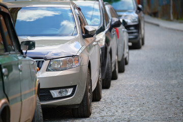 Fototapeta na wymiar City traffic with cars parked in line on street side