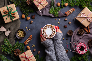 Christmas, female hands with gift boxes and cup of coffee