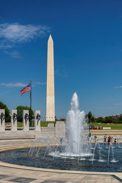 World War II Memorial fountain and Washington Monument in sunny summer day in Washington DC, USA
