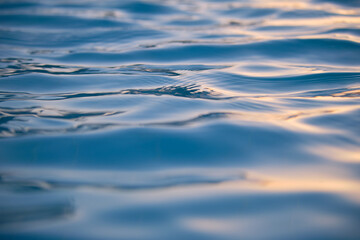 Closeup seascape surface of blue sea water with small ripple waves