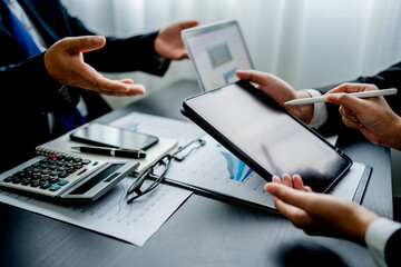 Close up of businessmen groups using digital tablet and laptop working analyzing business reports at the workplace, Business people discussing plan new project, chart, graph, marketing and financial