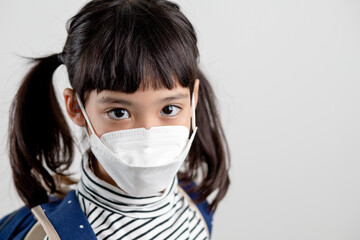 Child with face mask going back to school after covid-19 quarantine and lockdown.