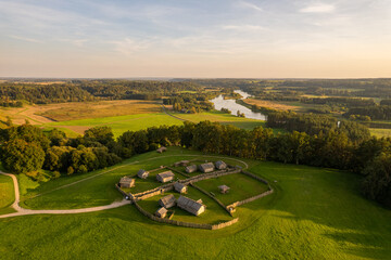 Aerial autumn evening sunset view of Kernavė archaeological site, mounds, Neris river