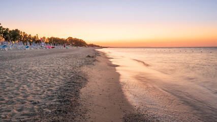 Aerial view of adriatic sea and sandy beach at sunrise, seascape and hill mountain on background, Simeri Mare, Calabria, Southern Italy