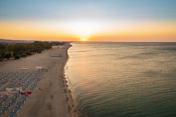 Aerial view of adriatic sea and sandy beach at sunrise, seascape and hill mountain on background,...