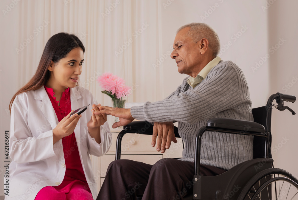 Wall mural nurse checking blood sugar of an old man