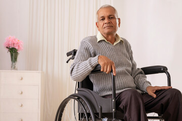 Sick old man sitting on wheel chair alone