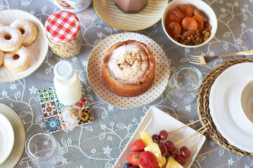 top view homemade breakfast with fruit, milk, sponge cake and cereals