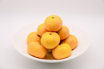 Tangerines in a white bowl.
