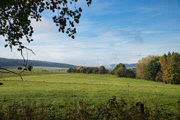 In Saarland forests, meadows and solitary trees in autumn look.