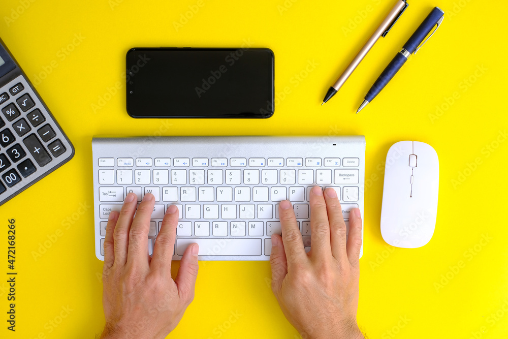 Poster man hands on the keyboard of a personal computer in the office or at home, suitable for both freelan