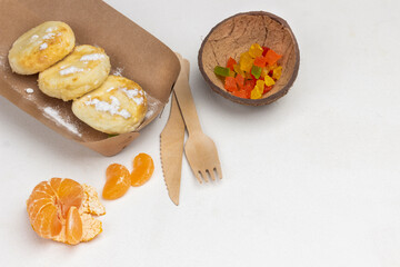 Cottage cheese pancakes in disposable plate, fork and knife.