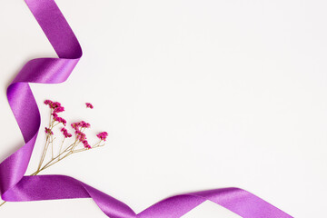 Red nature flowers with purple ribbon over the white background. 