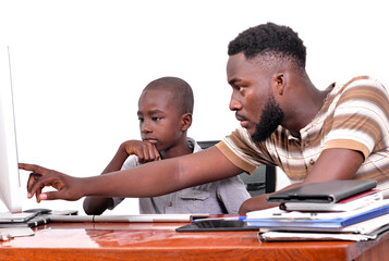 young father teaches his little boy to use a laptop.